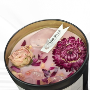 Ignite love and tranquility with the Love Candle, featuring a captivating pink hue, fragrant herbs, crystals, and a delightful rose and patchouli scent.